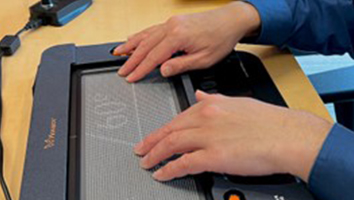 A person using a multiline braille display